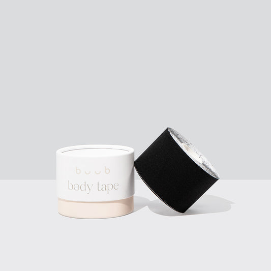 Product image of Buub Body Tape in black. The standard width roll of fabric breast tape is displayed next to its branded cylindrical box on a clean background.